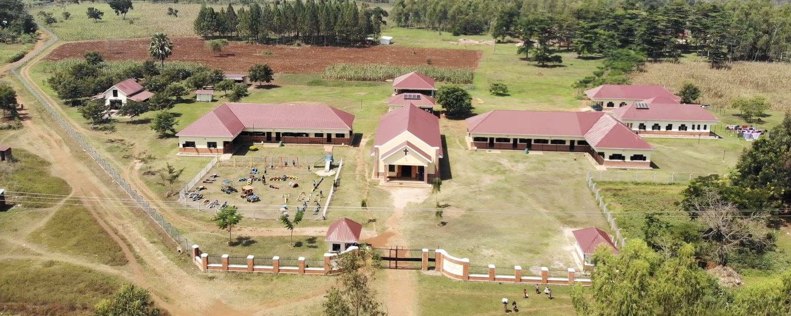 Aerial view of the Hope58 campus in Bulesa, showing classrooms, the church and the surrounding farmland