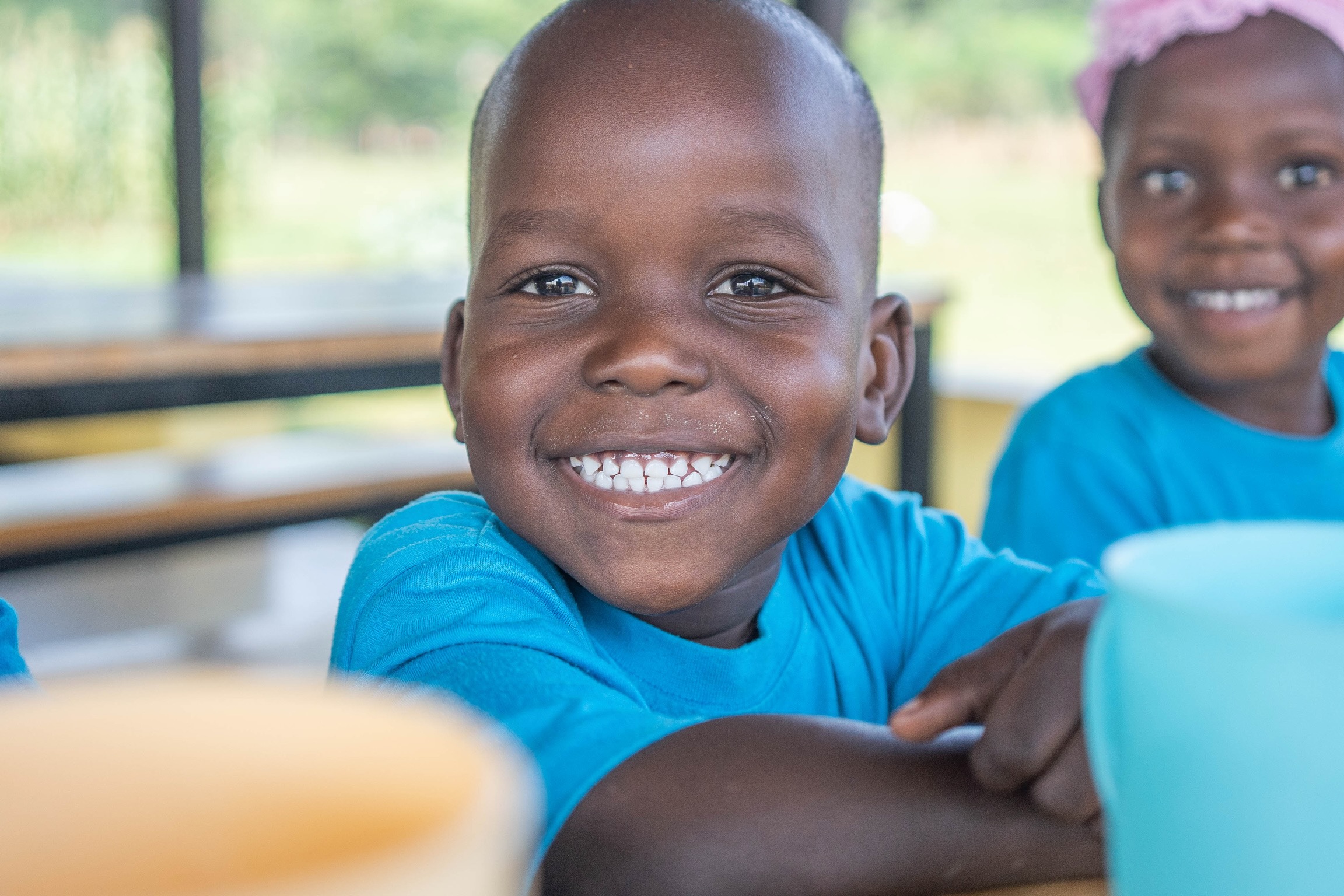 A preschooler smiling at New Beginnings Preschool